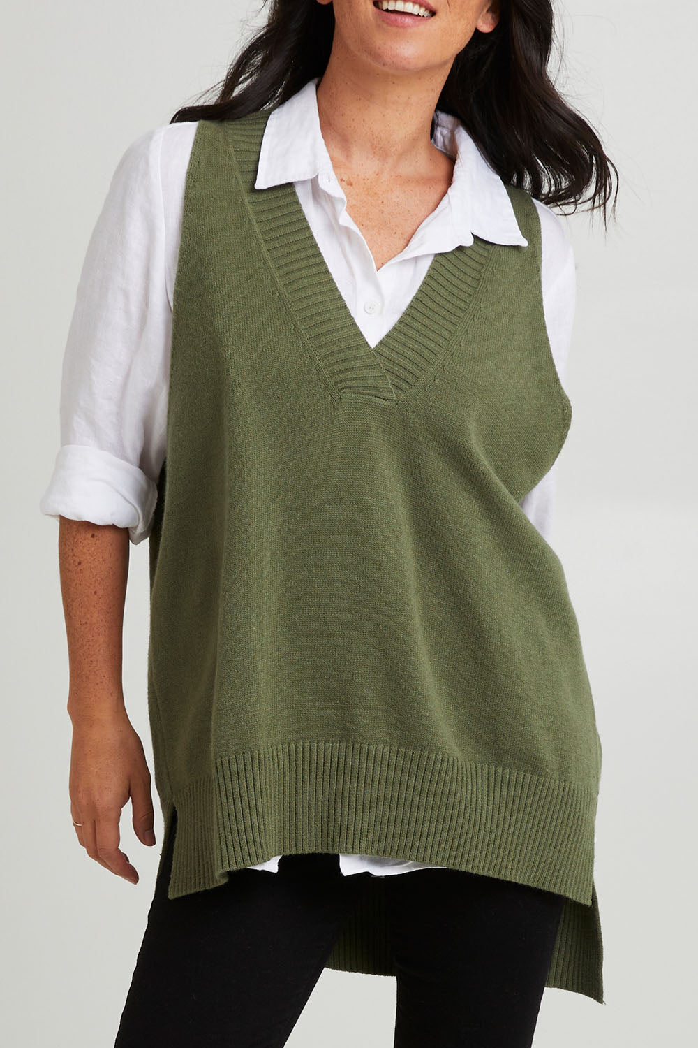 Model Katie wearing size S of the Nakako Vest in colour Moss (Green), from the front, cropped image
