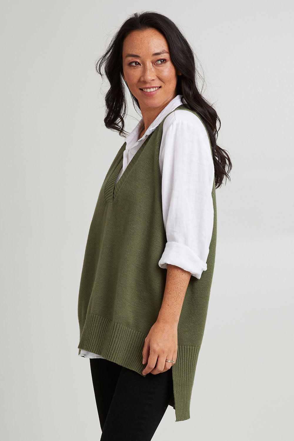 Model Katie wearing size S of the Nakako Vest in colour Moss (Green), from the front, cropped image
