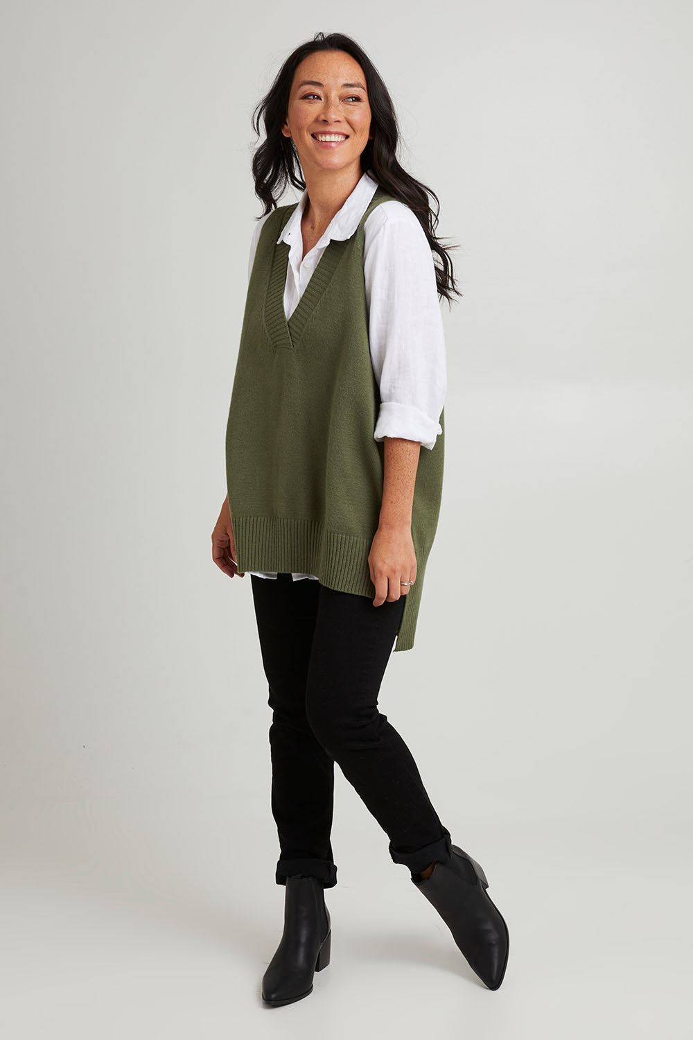 Model Katie wearing size S of the Nakako Vest in colour Moss (Green), from the front, showing the whole outfit