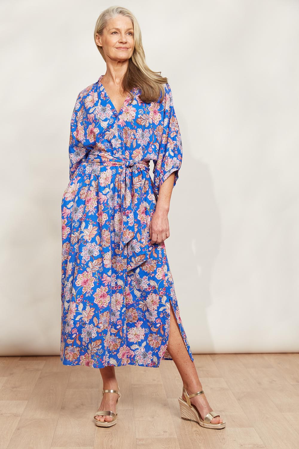 A model wearing the Seraphic Tie Dress in colour Palme (Blue), from the front, showing the whole outfit