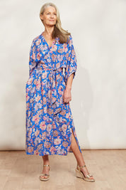 A model wearing the Seraphic Tie Dress in colour Palme (Blue), from the front, showing the whole outfit