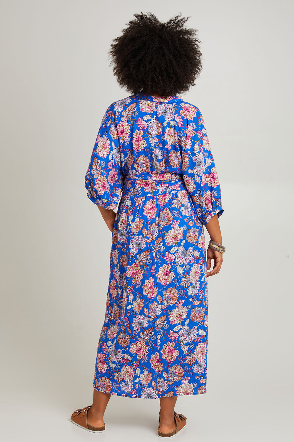 Model Olivia wearing size S of the Seraphic Tie Dress in colour Palme (Blue), from the back
