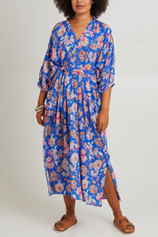 Model Olivia wearing size S of the Seraphic Tie Dress in colour Palme (Blue), from the front, cropped image
