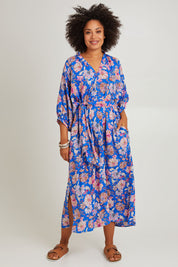 Model Olivia wearing size S of the Seraphic Tie Dress in colour Palme (Blue), from the front, showing the whole outfit