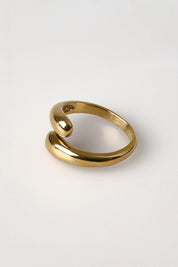 A model wearing the Halcyon Wrap Ring in colour Gold (Metallics), from the front, showing the whole outfit