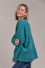 A model wearing the Folie Relaxed Knit in colour Largo (Blue), from the front, cropped image