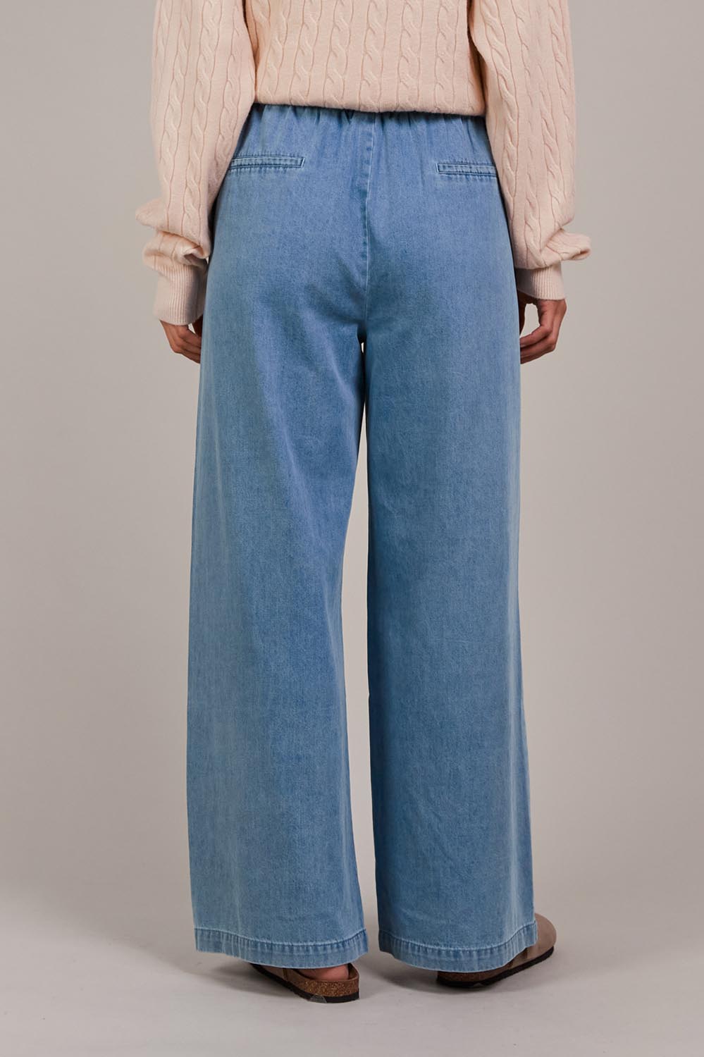A model wearing the Pepi Wide Leg Denim Pant in colour Denim (Blue), from the back
