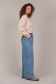 A model wearing the Pepi Wide Leg Denim Pant in colour Denim (Blue), from the front, showing the whole outfit