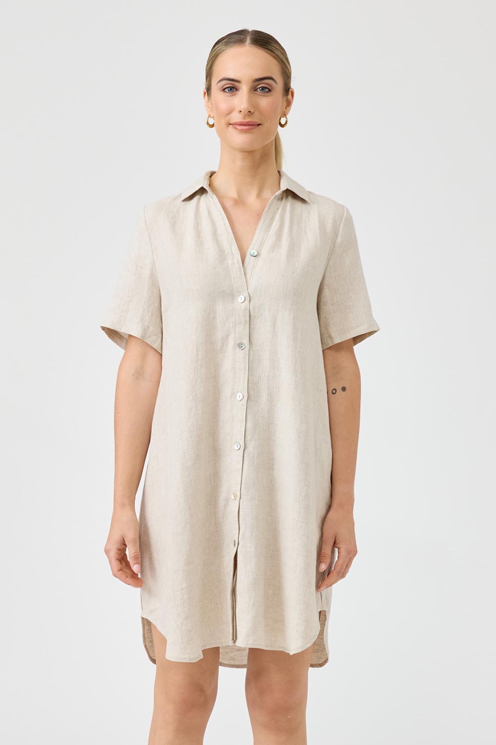 A model wearing the Studio Linen Short Shirt Dress in colour Dune, from the front, cropped image
