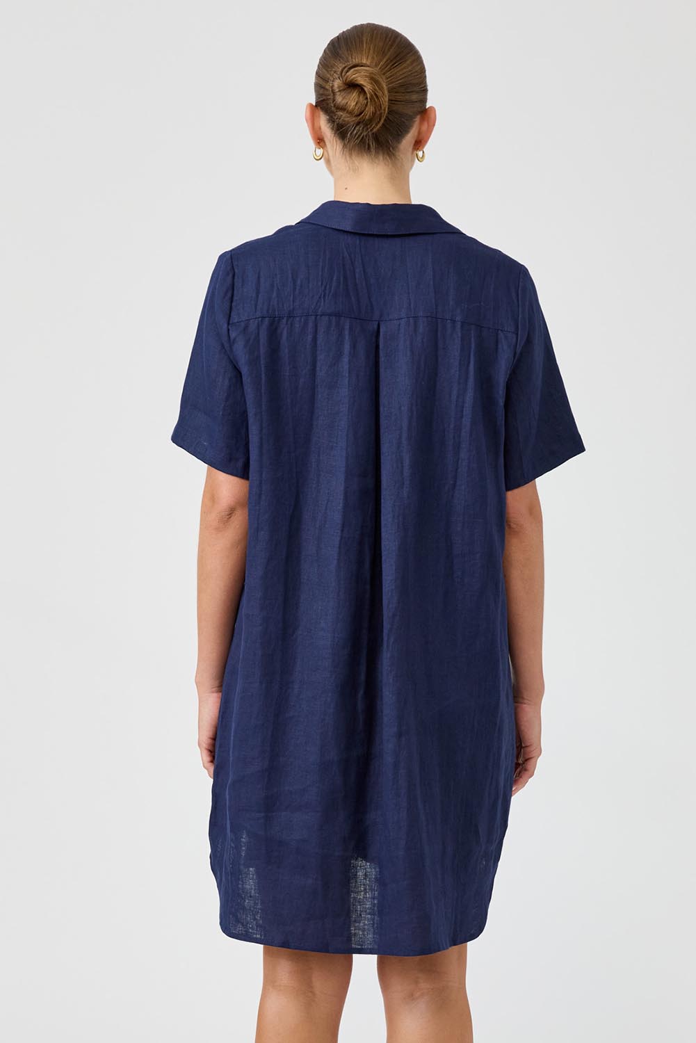 A model wearing the Studio Linen Short Shirt Dress in colour Navy (Blue), from the back