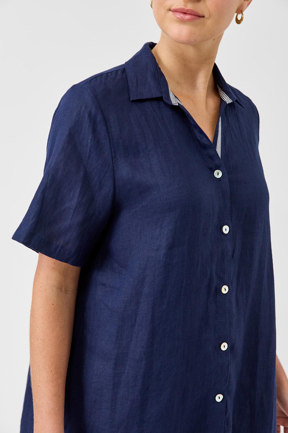 A model wearing the Studio Linen Short Shirt Dress in colour Navy (Blue), from the front, cropped image