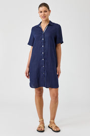 A model wearing the Studio Linen Short Shirt Dress in colour Navy (Blue), from the front, showing the whole outfit