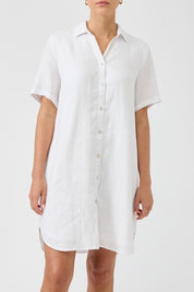 A model wearing the Studio Linen Short Shirt Dress in colour White (White), from the front, cropped image