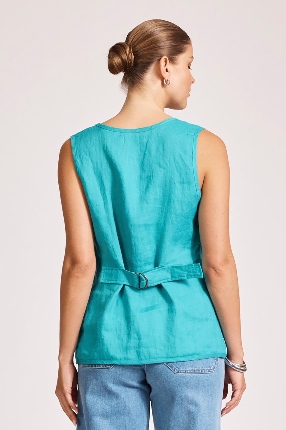A model wearing the Miramar Linen Vest in colour Lagoon (Blue), from the back