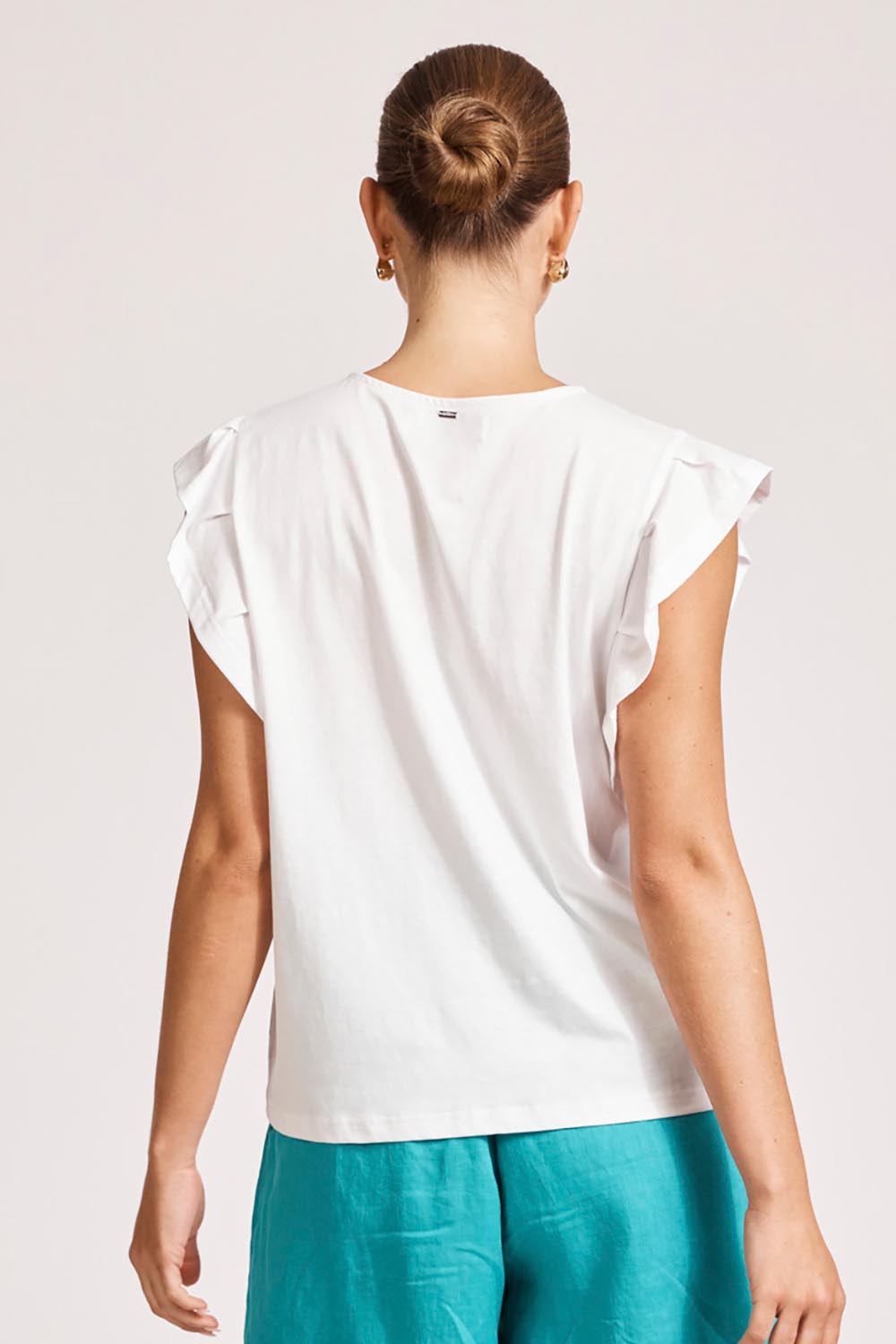 A model wearing the Francia Frill Cotton Tank in colour White (White), from the back