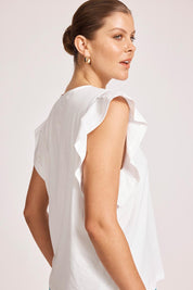 A model wearing the Francia Frill Cotton Tank in colour White (White), from the front, cropped image