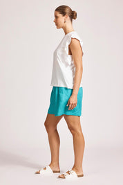 A model wearing the Francia Frill Cotton Tank in colour White (White), from the front, showing the whole outfit