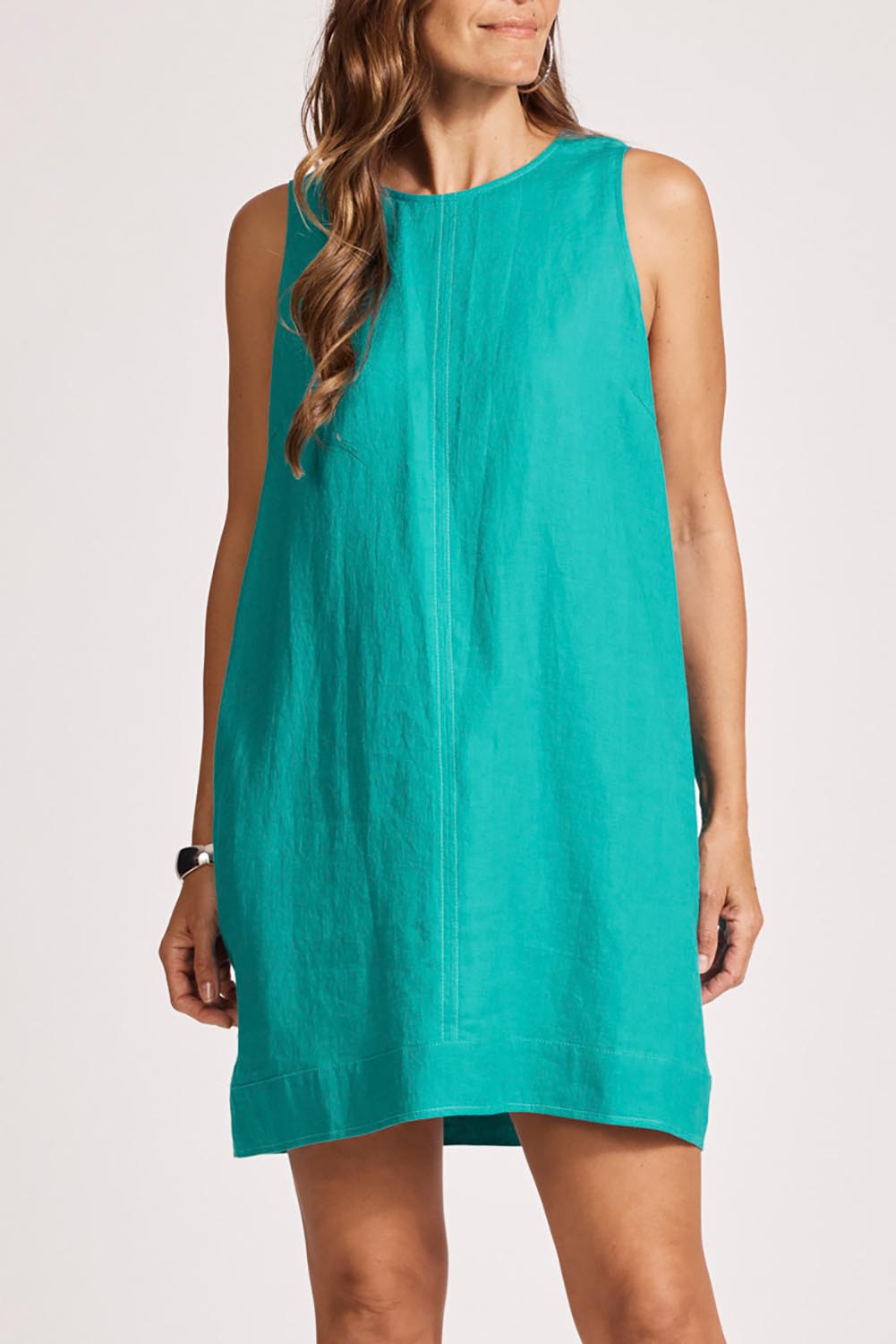 A model wearing the Miramar Linen Tank Dress in colour Lagoon (Blue), from the front, cropped image