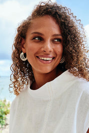 A model wearing the Matera Layer Wrap Hoops in colour White (White), from the front, showing the whole outfit