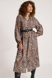 A model wearing the Bajau Button Dress in colour Nomad, from the front, cropped image
