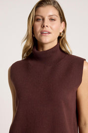 A model wearing the Zala Knit Vest in colour Mahogany (Red), from the front, cropped image