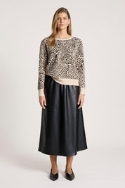 A model wearing the Zala Jumper in colour Nomad, from the front, showing the whole outfit