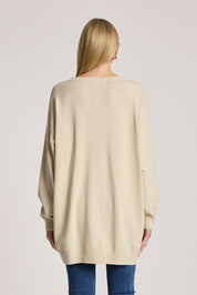 A model wearing the Samira Relaxed Knit in colour Bisque, from the back