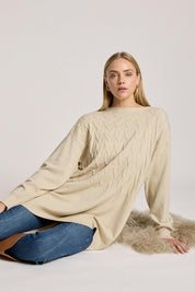 A model wearing the Samira Relaxed Knit in colour Bisque, from the front, cropped image