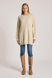 A model wearing the Samira Relaxed Knit in colour Bisque, from the front, showing the whole outfit