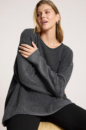 A model wearing the Apache Jumper in colour Black (Black), from the front, cropped image