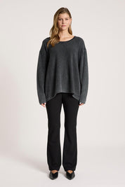 A model wearing the Apache Jumper in colour Black (Black), from the front, showing the whole outfit