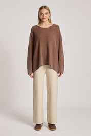 A model wearing the Apache Jumper in colour Coco, from the front, showing the whole outfit