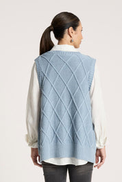 A model wearing the Liora Knit Vest in colour Lake (Blue), from the back