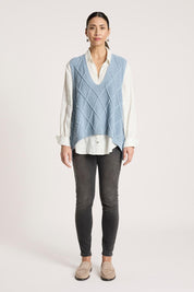 A model wearing the Liora Knit Vest in colour Lake (Blue), from the front, showing the whole outfit