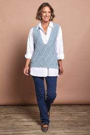Model Riina wearing size S of the Liora Knit Vest in colour Lake (Blue), from the front, showing the whole outfit