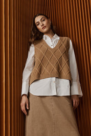 A model wearing the Liora Knit Vest in colour Mocha, from the front, showing the whole outfit
