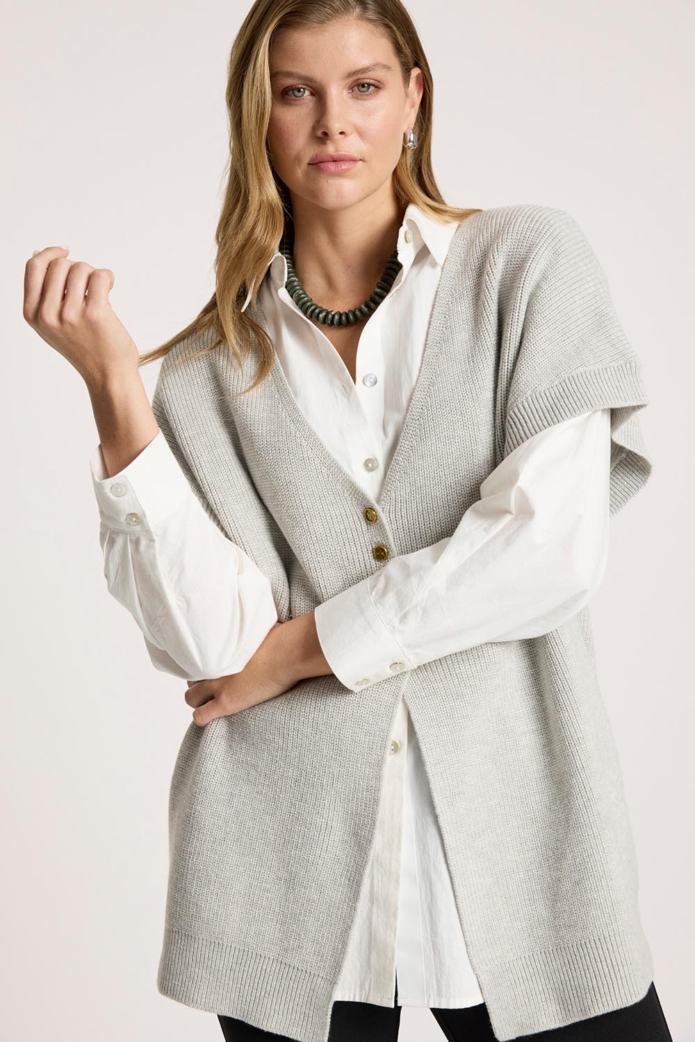 A model wearing the Berber Vest Cardigan in colour Marle (Grey), from the front, cropped image