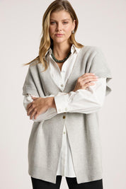 A model wearing the Berber Vest Cardigan in colour Marle (Grey), from the front, cropped image