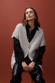 A model wearing the Berber Vest Cardigan in colour Marle (Grey), from the front, showing the whole outfit