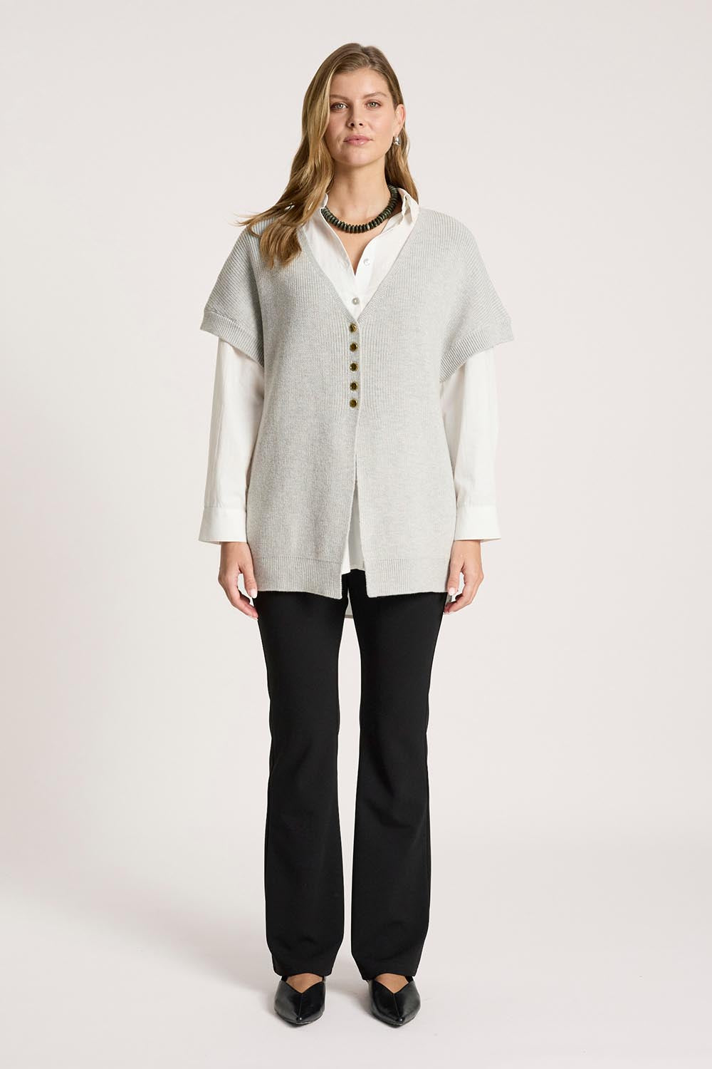 A model wearing the Berber Vest Cardigan in colour Marle (Grey), from the front, showing the whole outfit