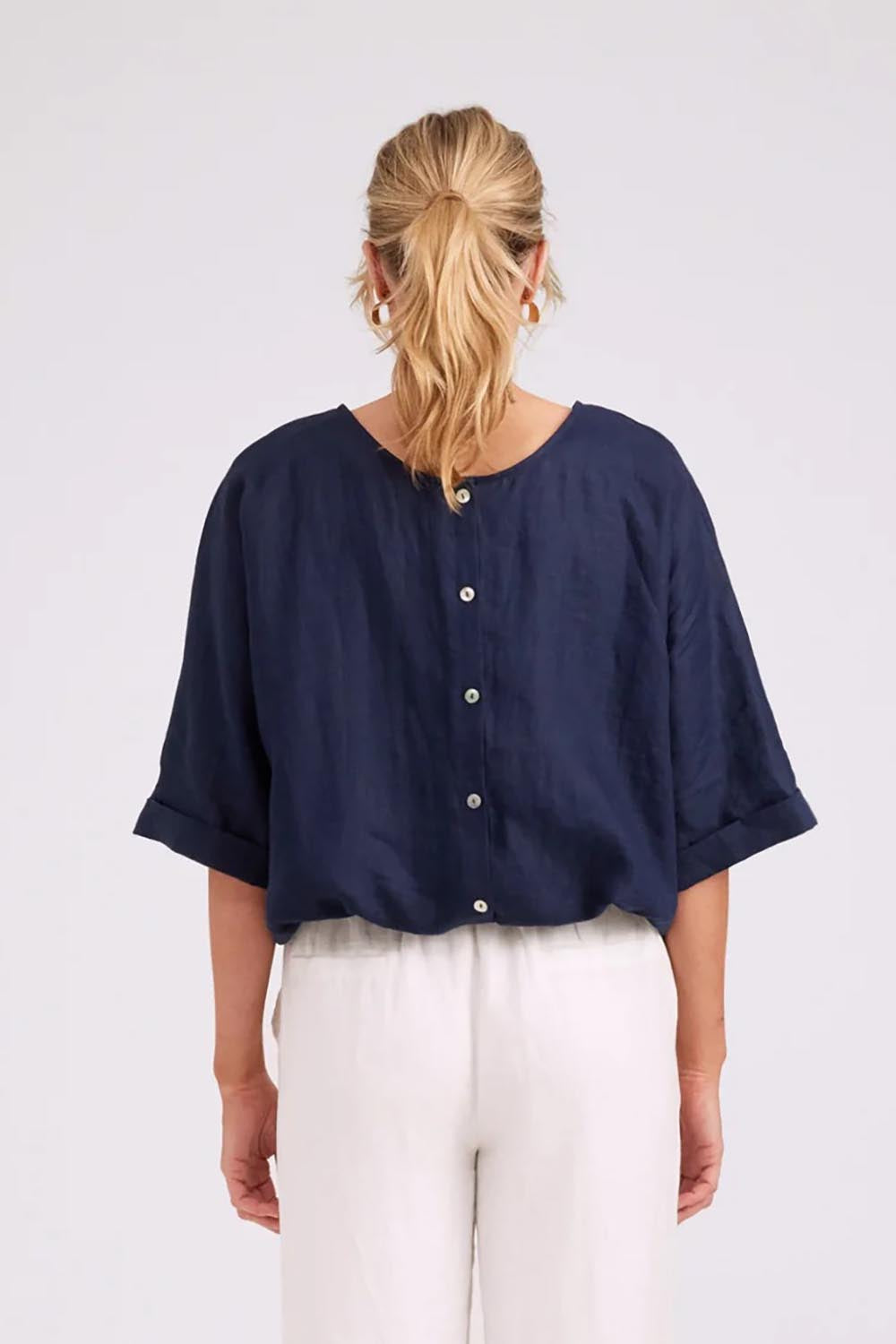 Model Genericm wearing size sample of the Studio Linen Button Top Jacket – Navy in colour Navy, from the back