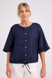 Model Genericm wearing size sample of the Studio Linen Button Top Jacket – Navy in colour Navy, in a cropped view