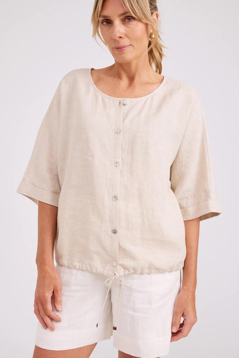 Model Genericm wearing size sample of the Studio Linen Button Top Jacket – Tusk in colour Tusk, in a cropped view