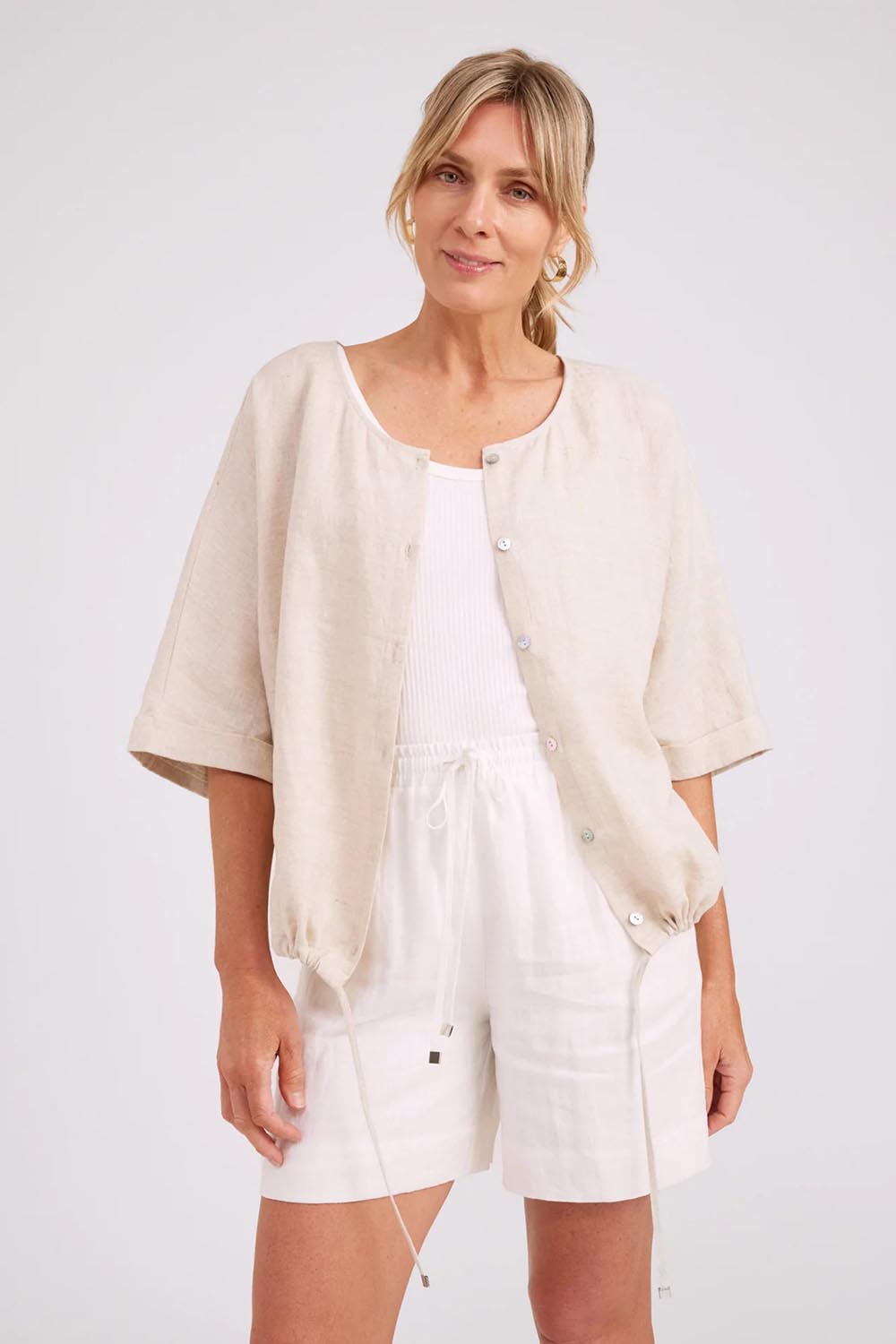 Model Genericm wearing size sample of the Studio Linen Button Top Jacket – Tusk in colour Tusk, in a cropped view