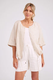 Model Genericm wearing size sample of the Studio Linen Button Top Jacket – Tusk in colour Tusk, in a cropped view