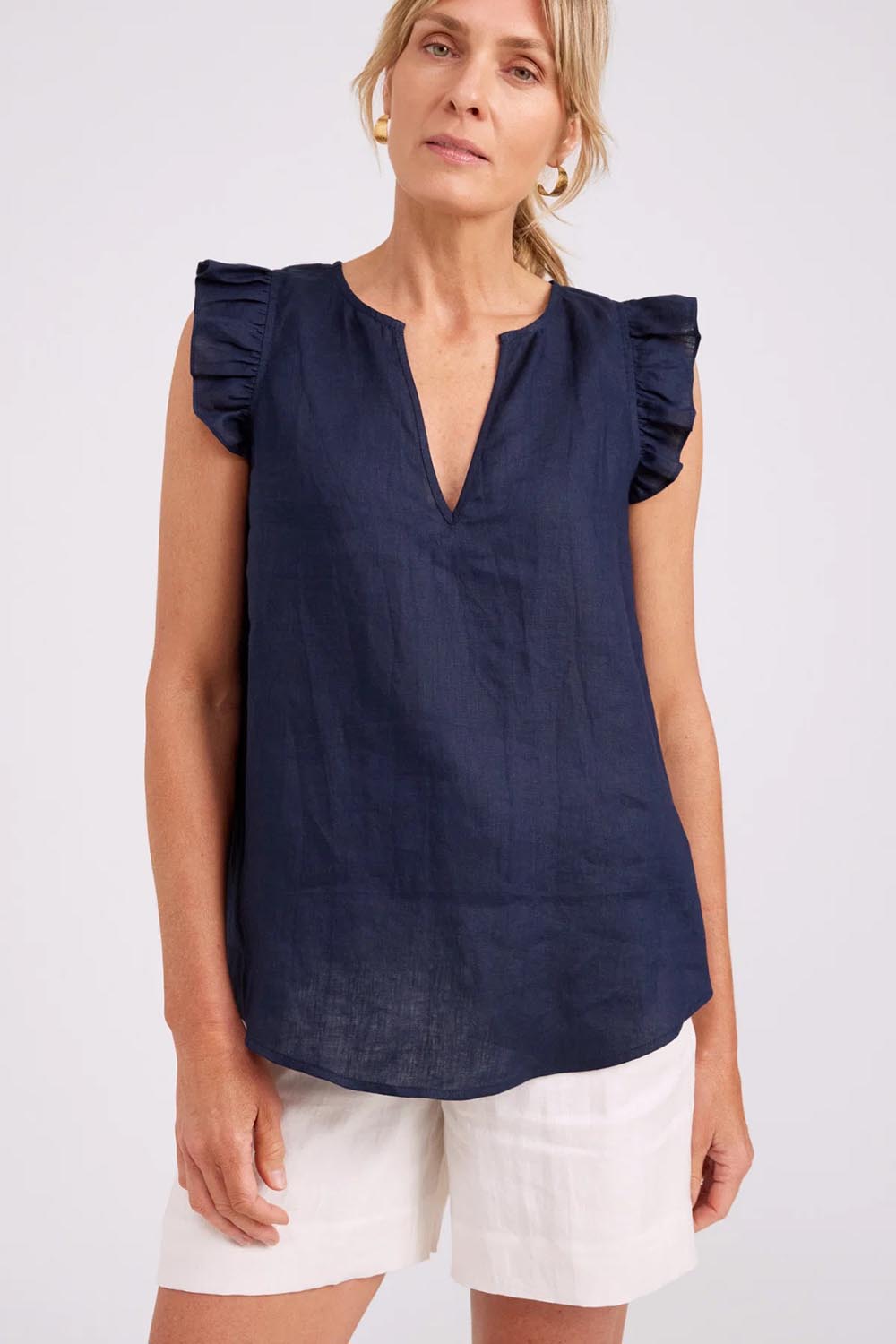 Model Genericm wearing size sample of the Studio Linen Frill Tank – Navy in colour Navy, in a cropped view