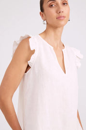 Model Genericm wearing size sample of the Studio Linen Frill Tank – White in colour White, in a cropped view