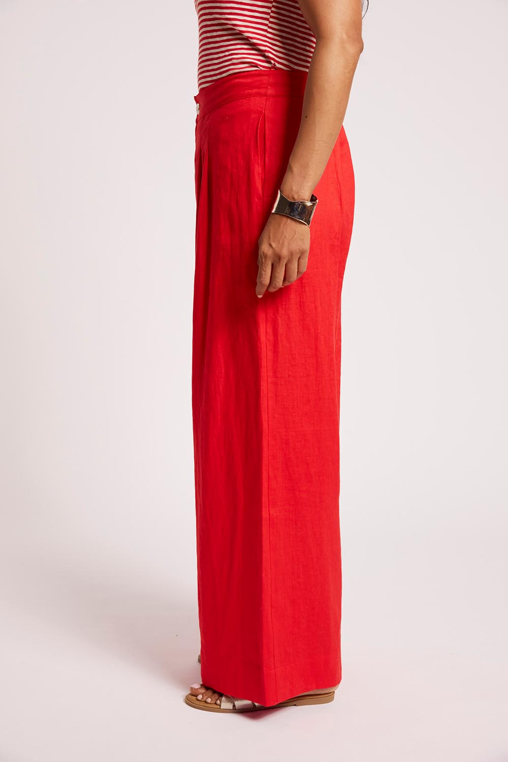 Model Genericm wearing size sample of the Cove Palazzo Pant – Aperol in colour Aperol, from an angle