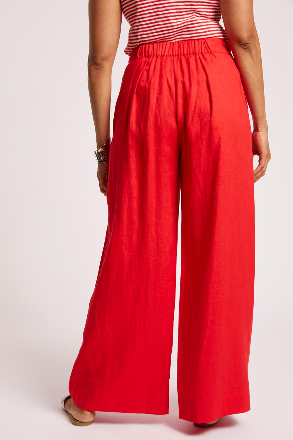 Model Genericm wearing size sample of the Cove Palazzo Pant – Aperol in colour Aperol, from the front