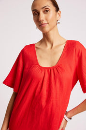 Model Genericm wearing size sample of the Cove Dress – Aperol in colour Aperol, in a cropped view